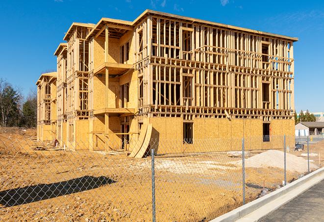 a close-up of temporary chain link fences enclosing a job site, signaling progress in the project's development in Coral Springs, FL